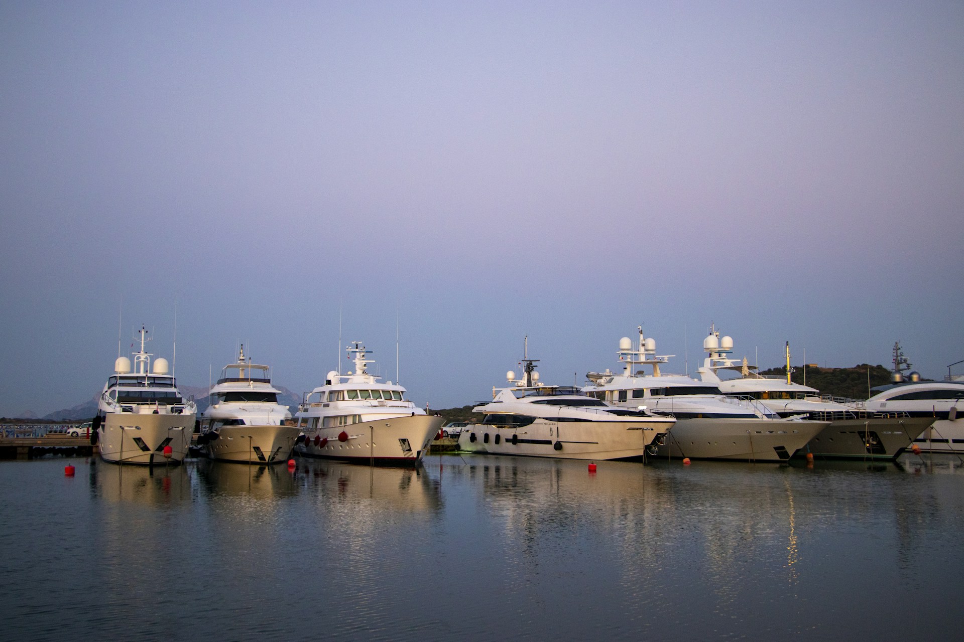six white yachts on dock