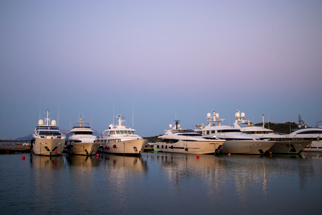 six white yachts on dock