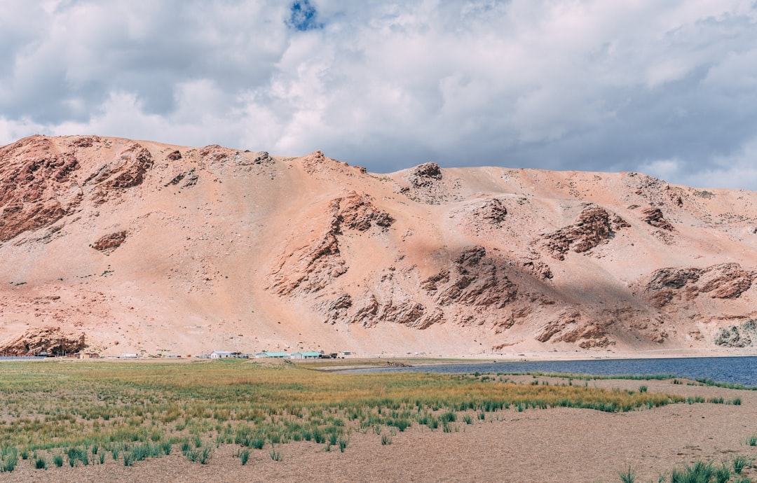 brown mountain under white clouds