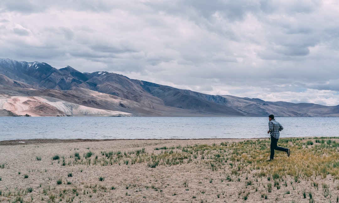 man running to lake