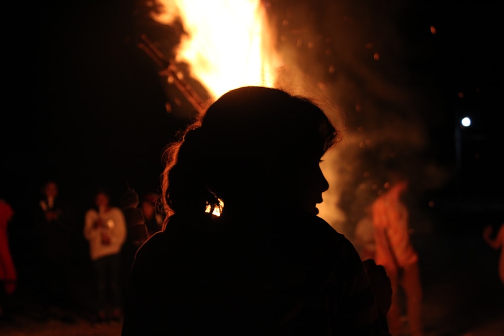 a person standing in front of a fire