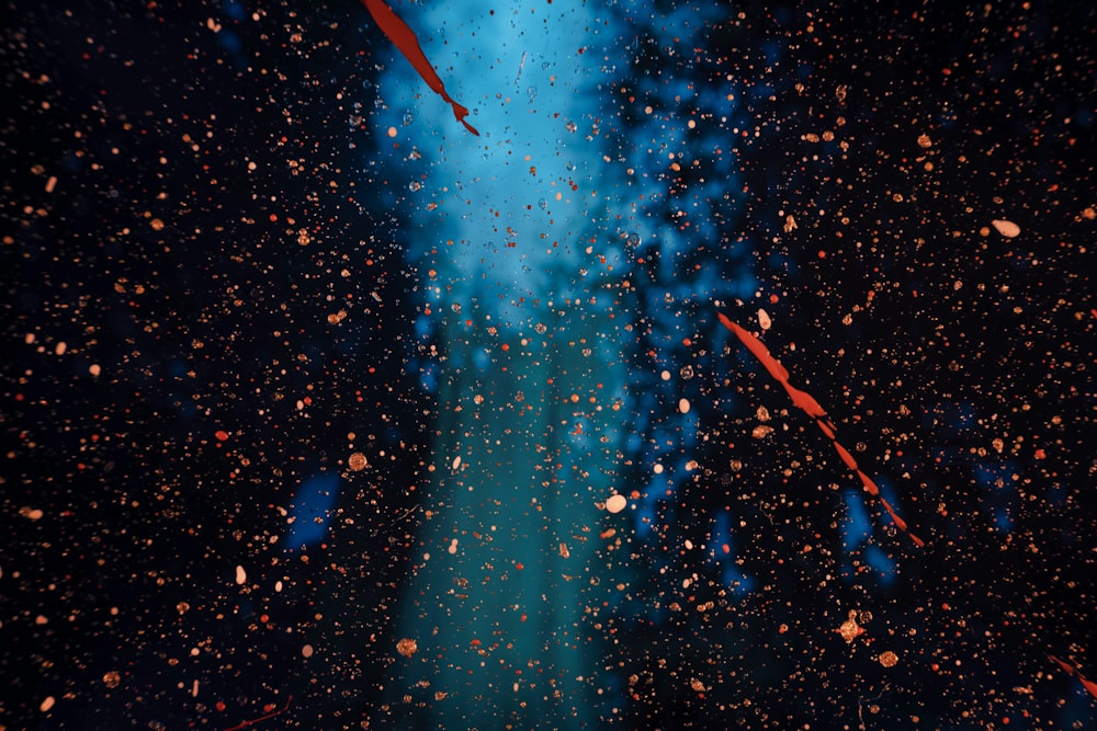 a blue and black background with a red umbrella