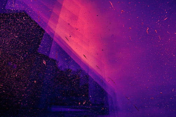 Abstract image of neon lights and floating debris.