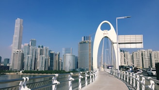 a bridge that has a very tall building in the background