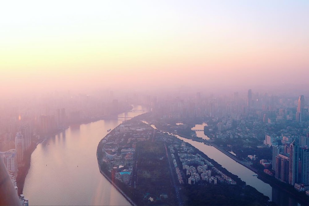 a river running through a city next to tall buildings