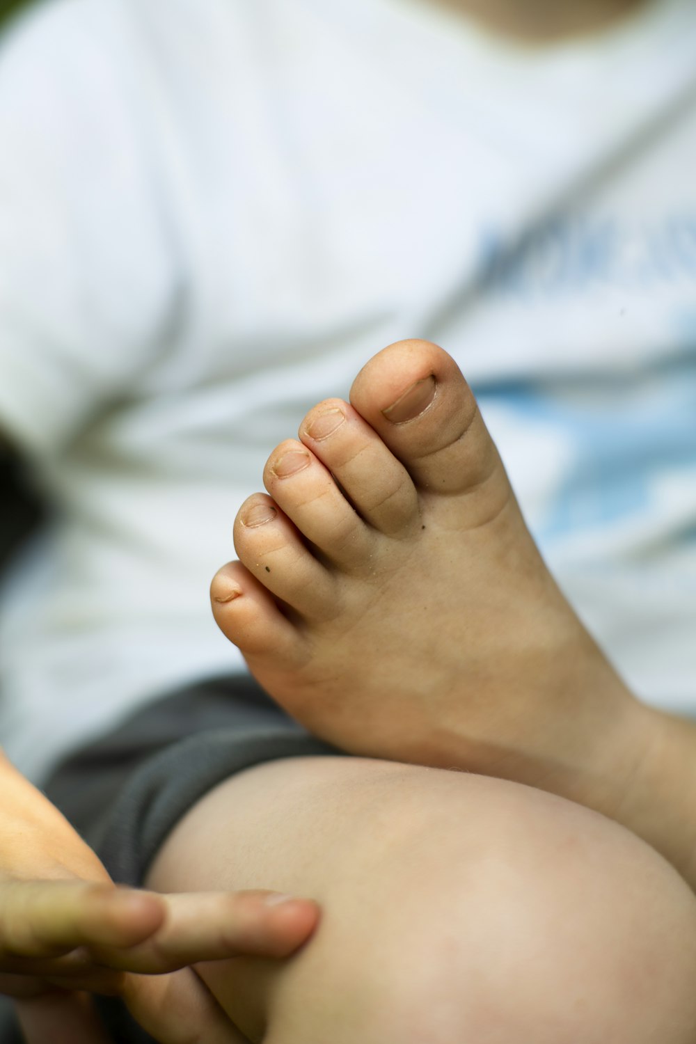 person putting left foot on lap of another person