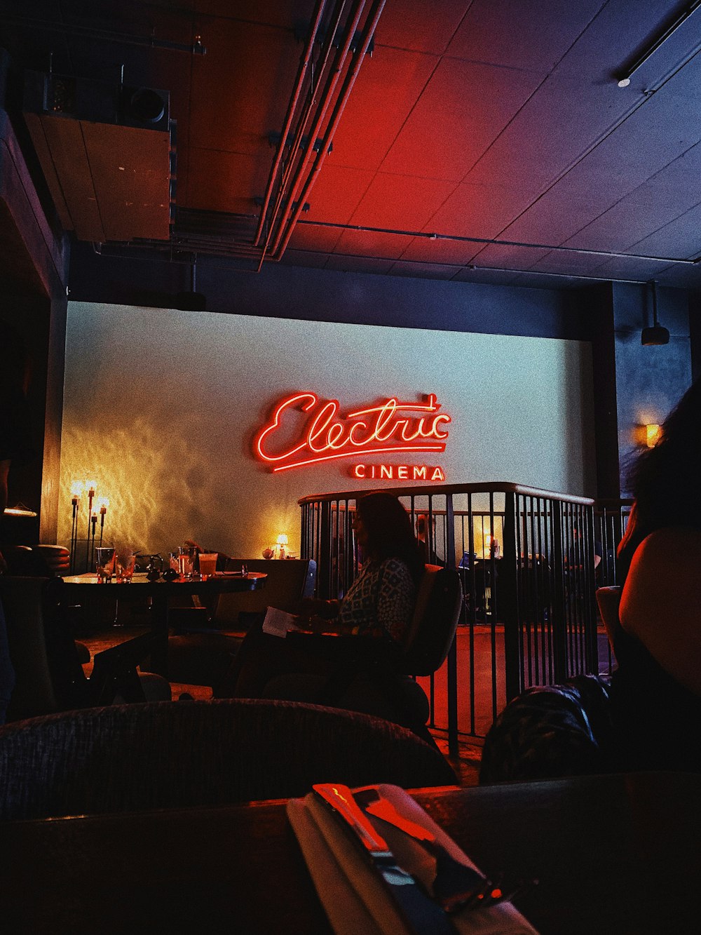 woman sitting near table inside electric cinema