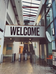 a sign that says welcome in a building