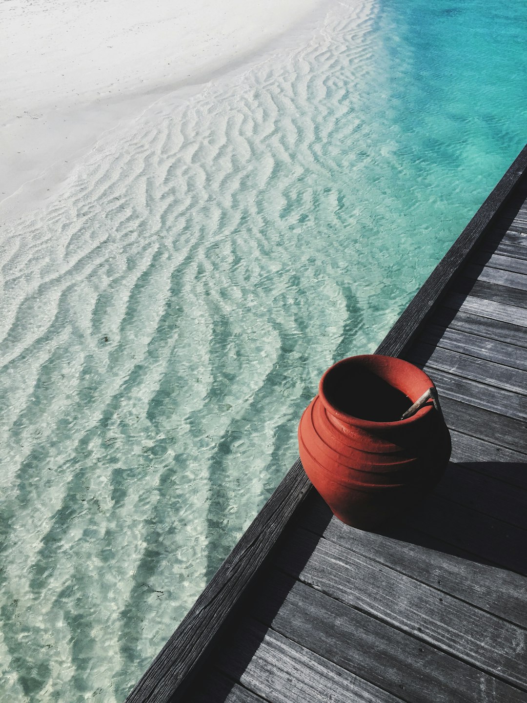 brown jar near water