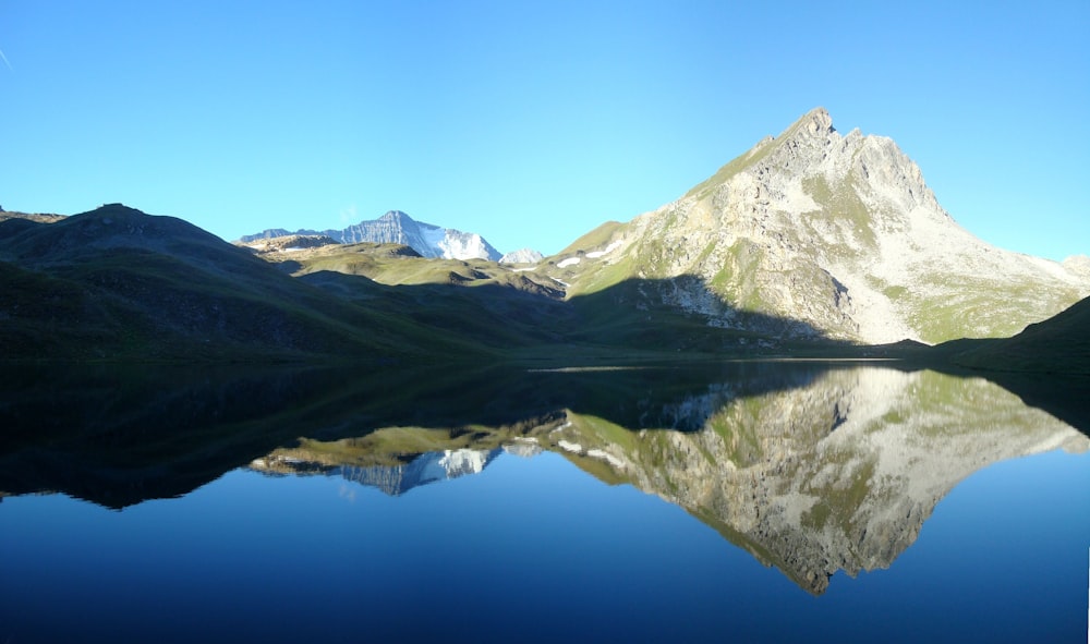 mountain covered with snow near lake