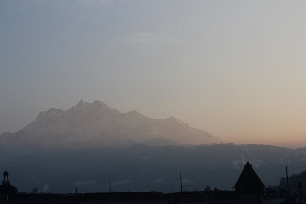 grey mountain under grey sky