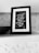 A black and white framed quote on a shelf, surrounded by a textured background. The quote reads, 'Look inside yourself; everything that you want, you are already that.' Attributed to Rumi, the text is written in a script font on a dark background.