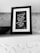 A black and white framed quote on a shelf, surrounded by a textured background. The quote reads, 'Look inside yourself; everything that you want, you are already that.' Attributed to Rumi, the text is written in a script font on a dark background.