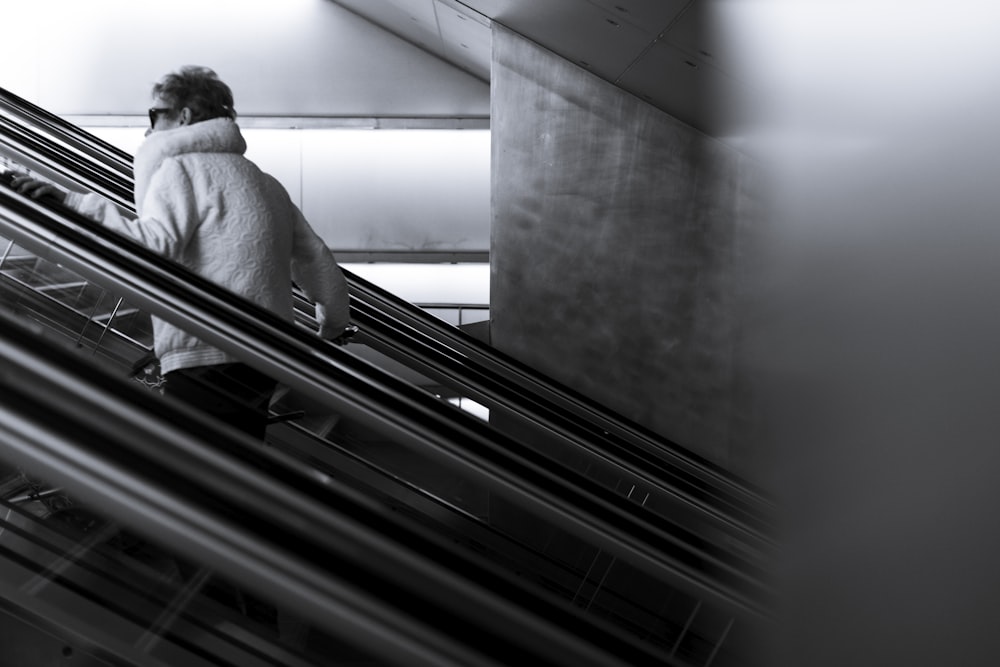 grayscale photography of man walking going up