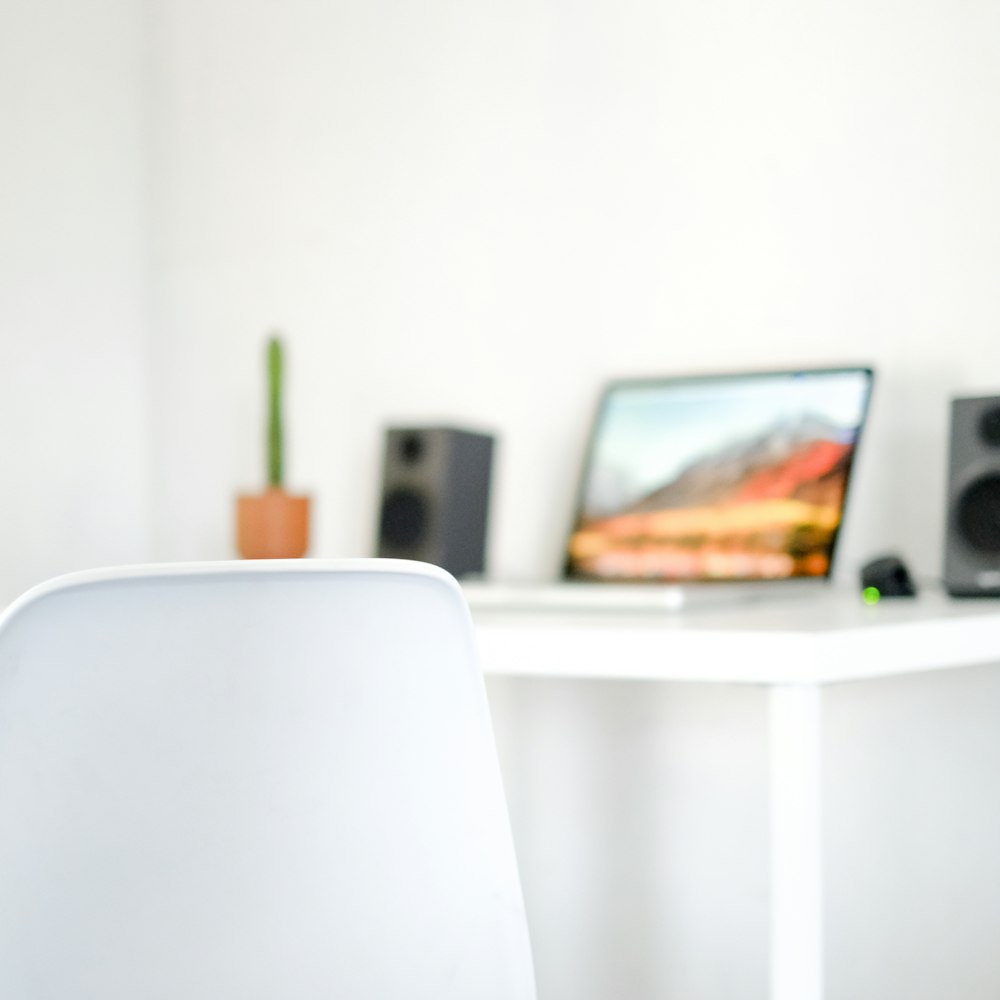 a white chair sitting in front of a white table