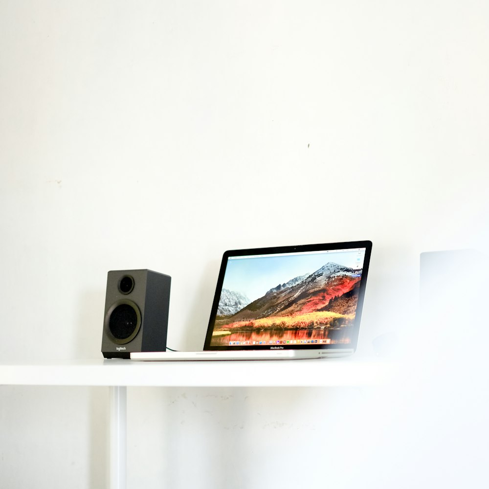 laptop beside speaker