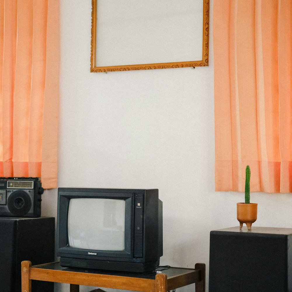 a small tv sitting on top of a wooden table