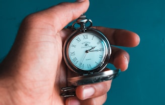 person holding pocket watch