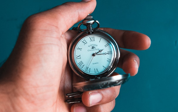 person holding pocket watch