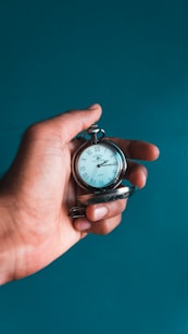 person holding pocket watch