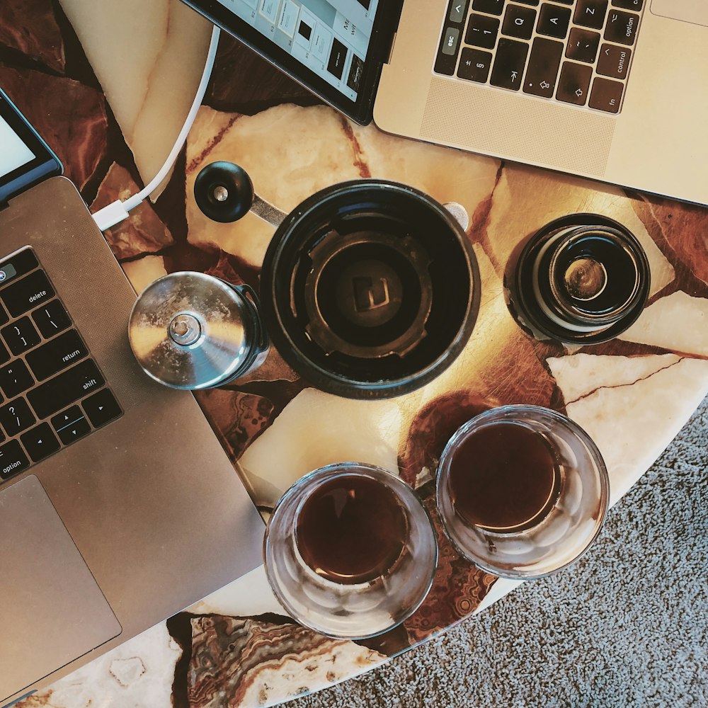 two drinking glass beside laptop