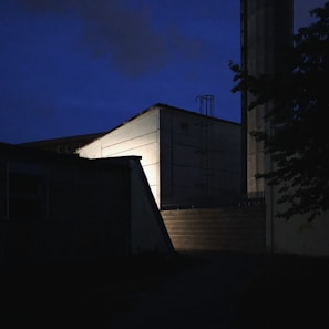 Evening shot of the factory exterior illuminated with dark blue and grey tones reflecting professionalism