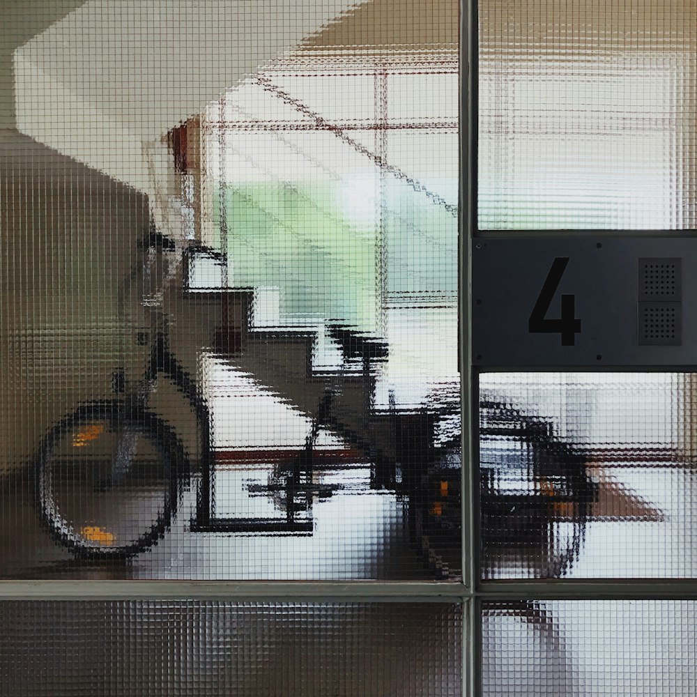 a bike is seen through a glass door