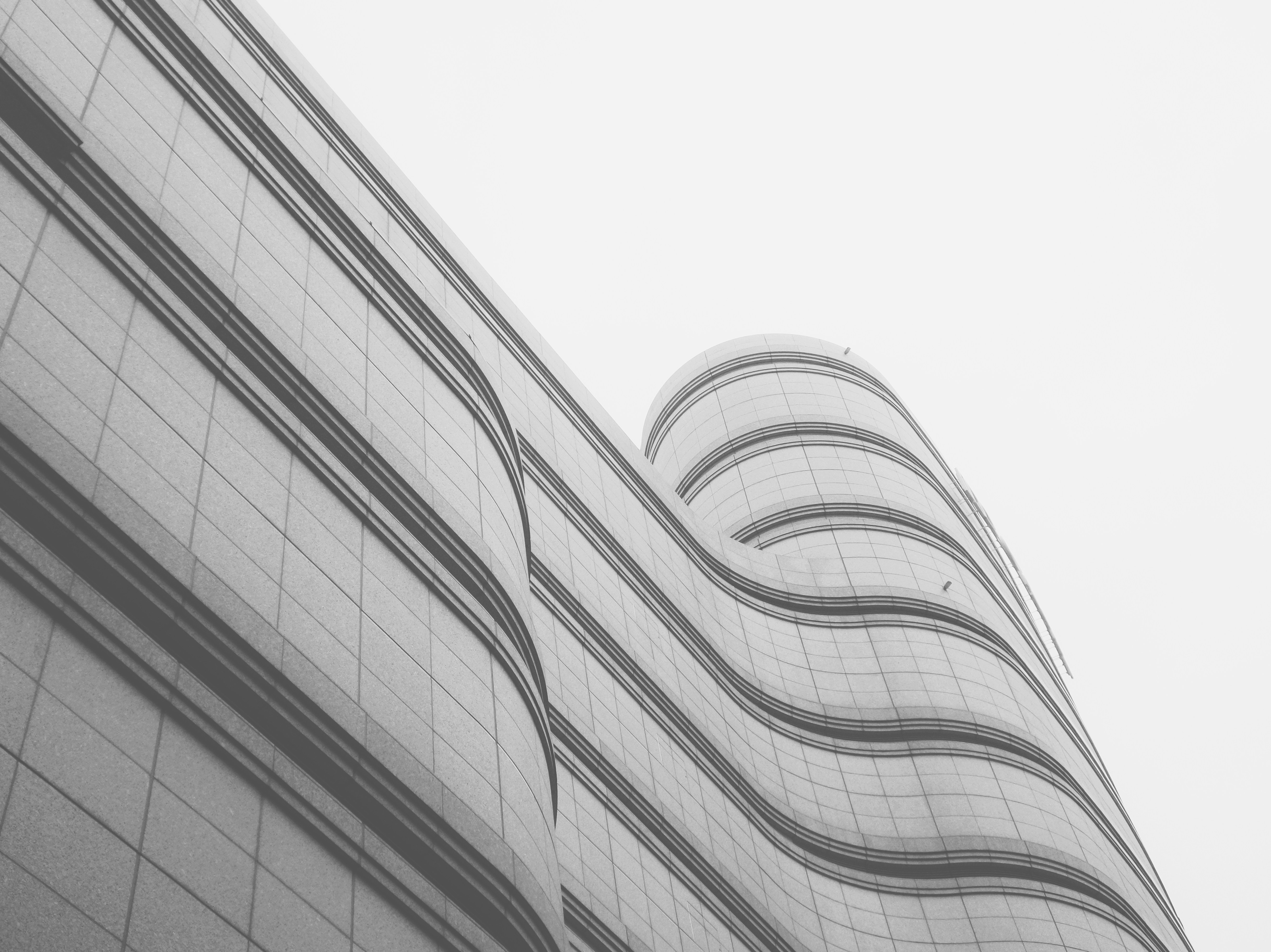 white and grey high rise building wavy teams background