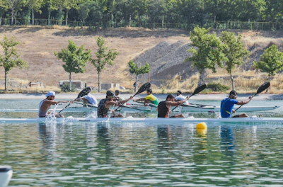 Kayakers paddling energetically across the calm waters of Shepherd Mountain Lake.