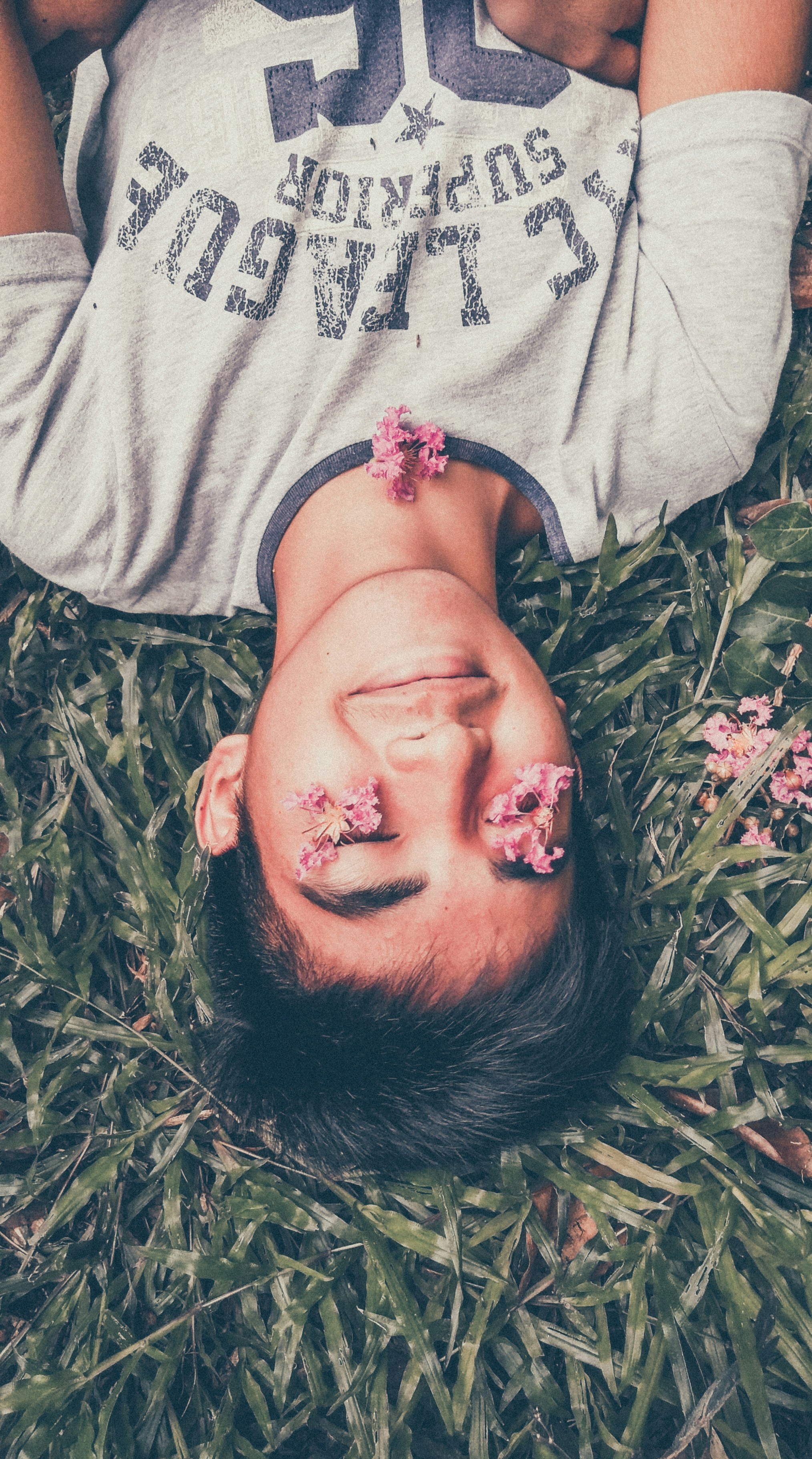 man lying on green grass