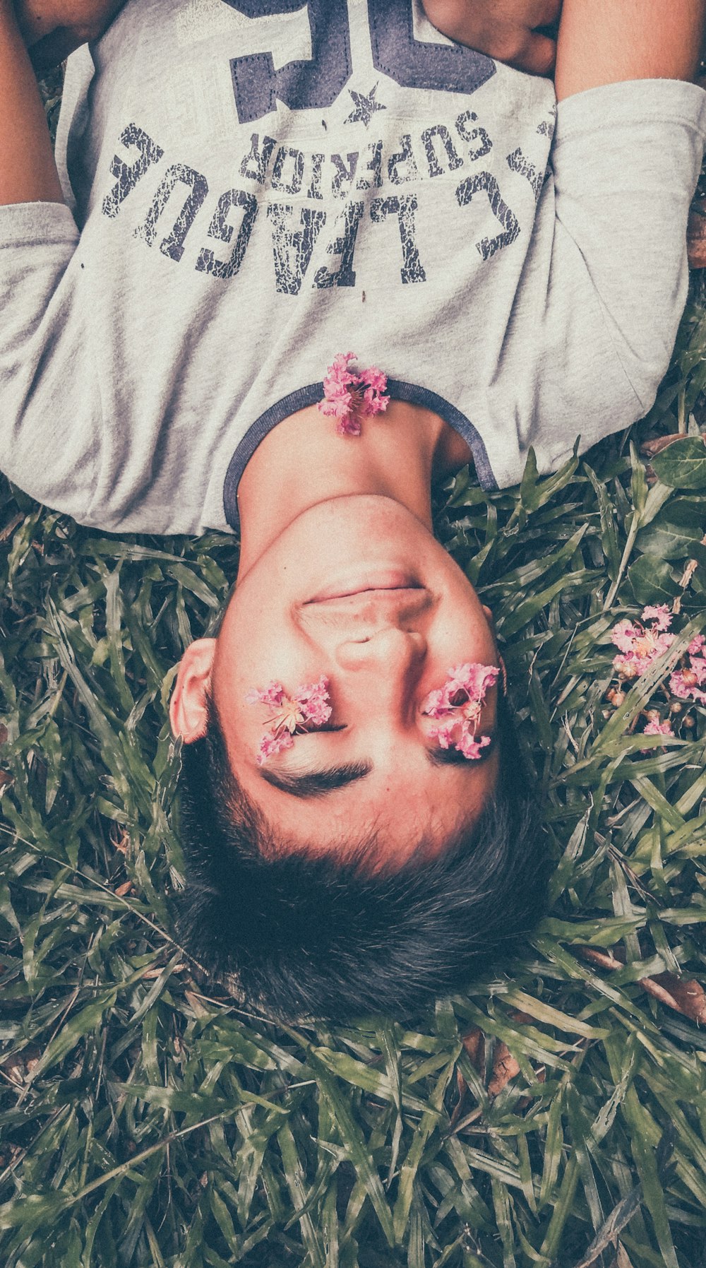man lying on green grass