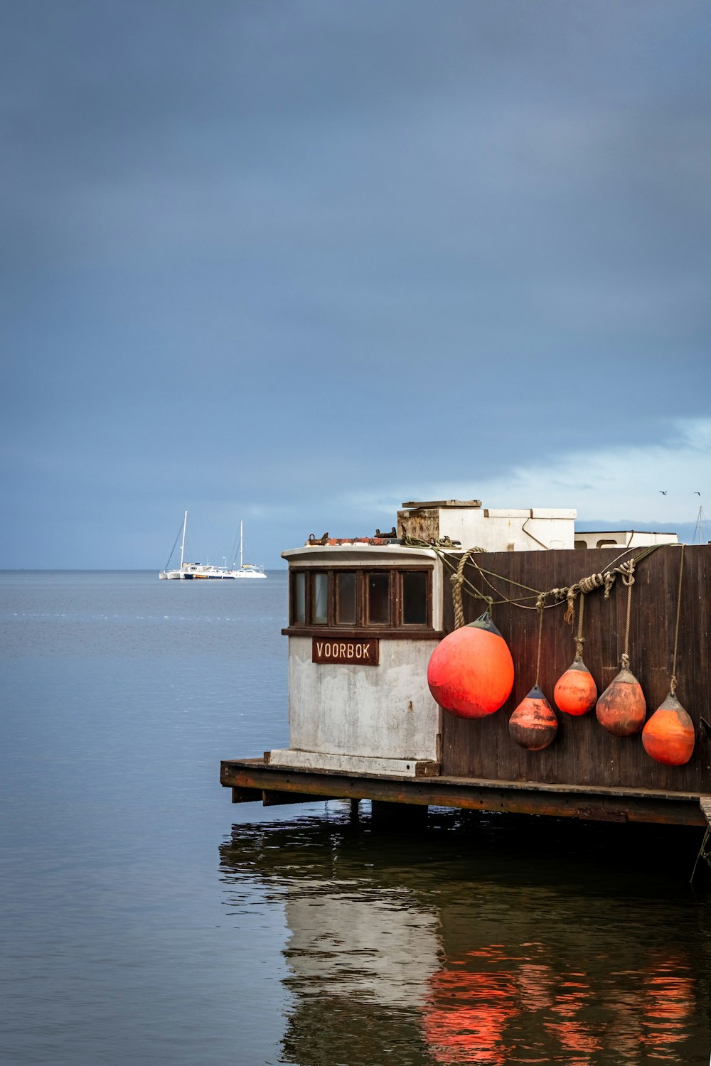 white and brown wooden house on body of water