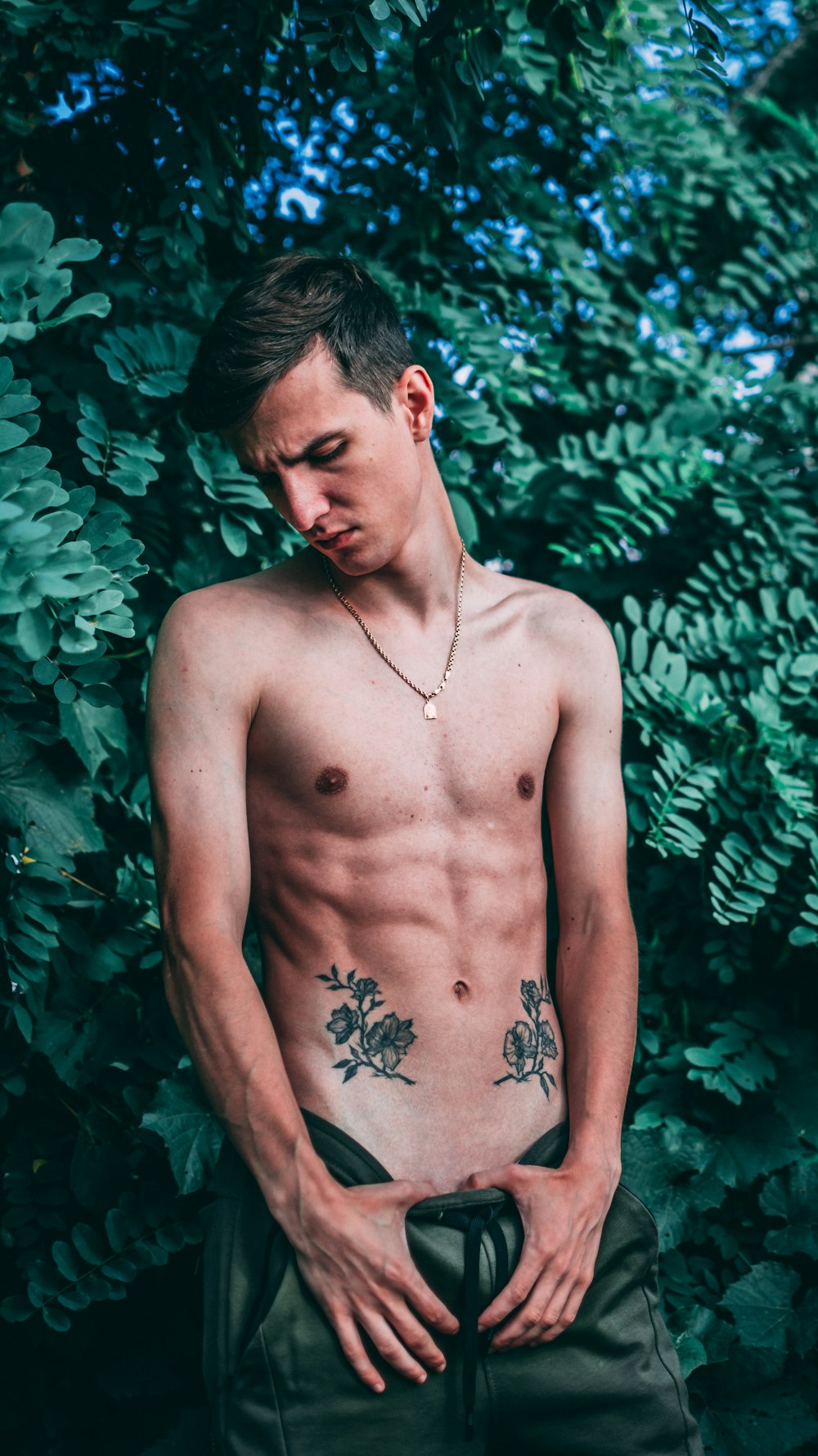 man standing beside plants