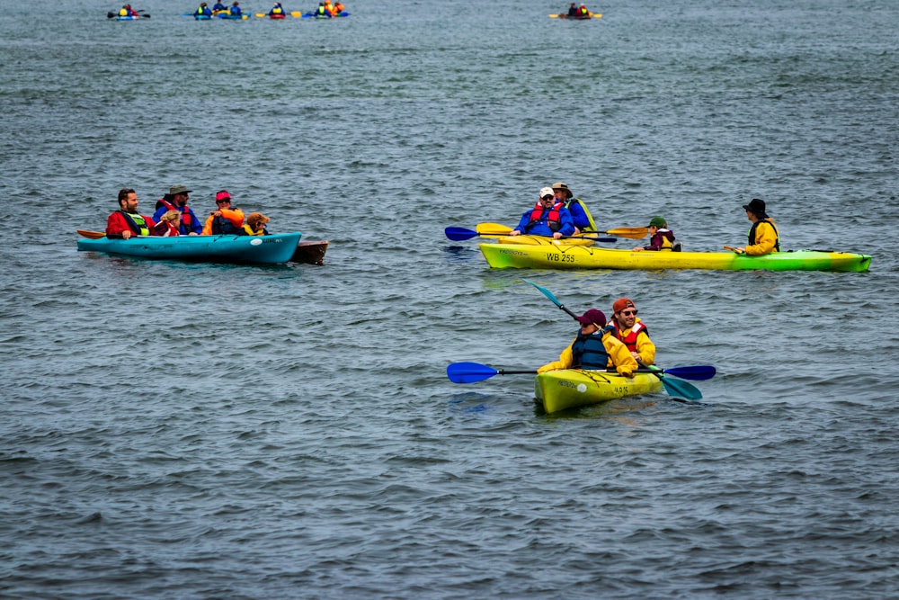 a group of people riding kayaks on top of a body of water