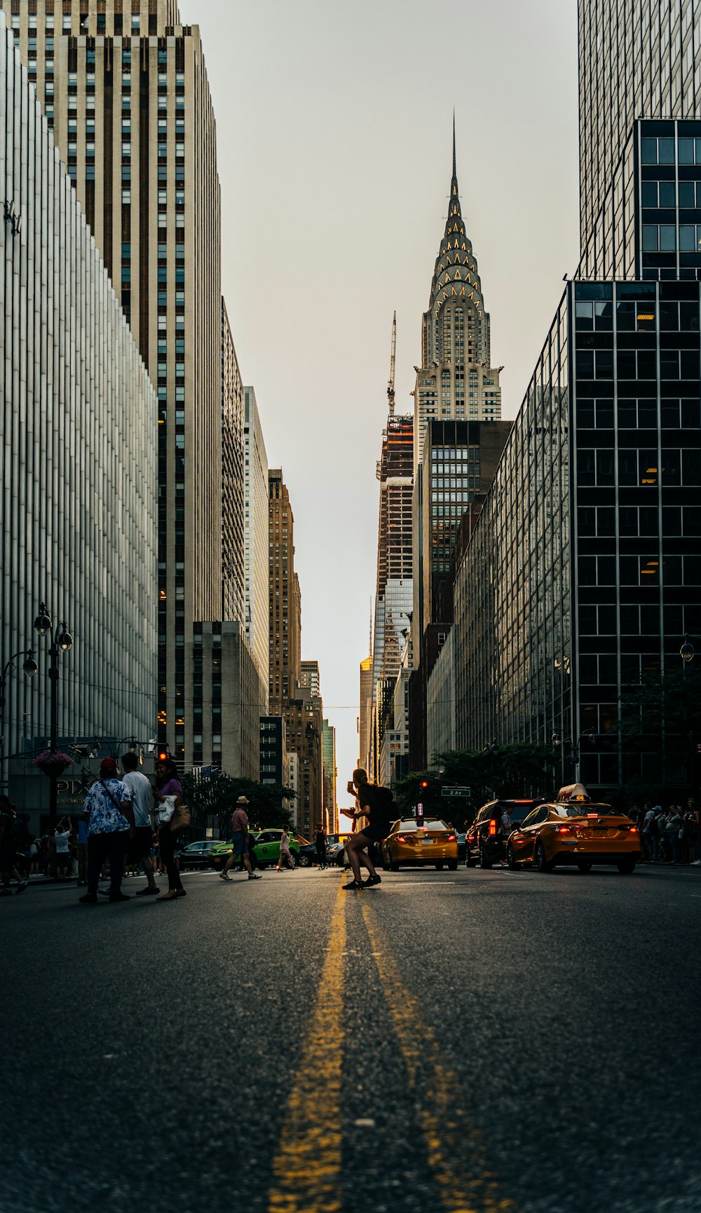 gray traffic road towards city buildings