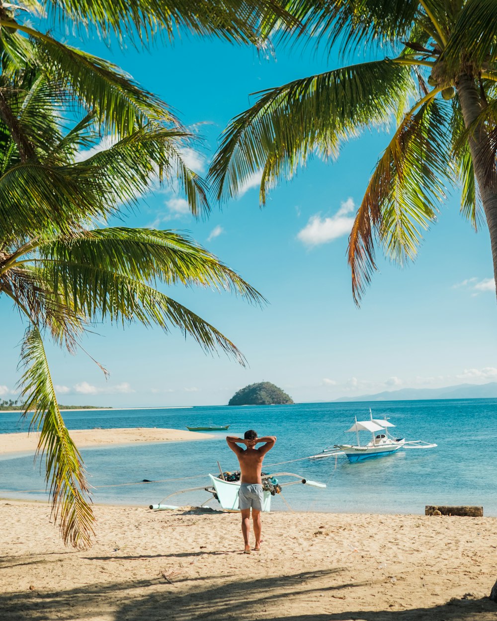 man standing near beach line