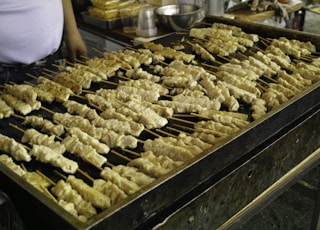 a person cooking food on a grill in a kitchen