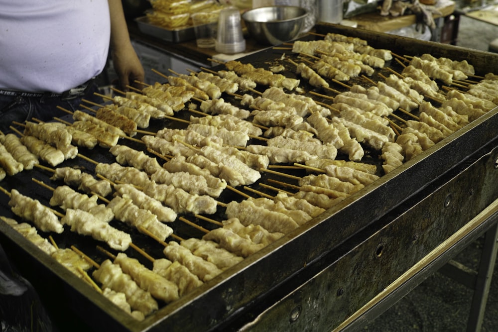 a person cooking food on a grill in a kitchen