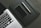 A close-up of a laptop and accessories on a desk.