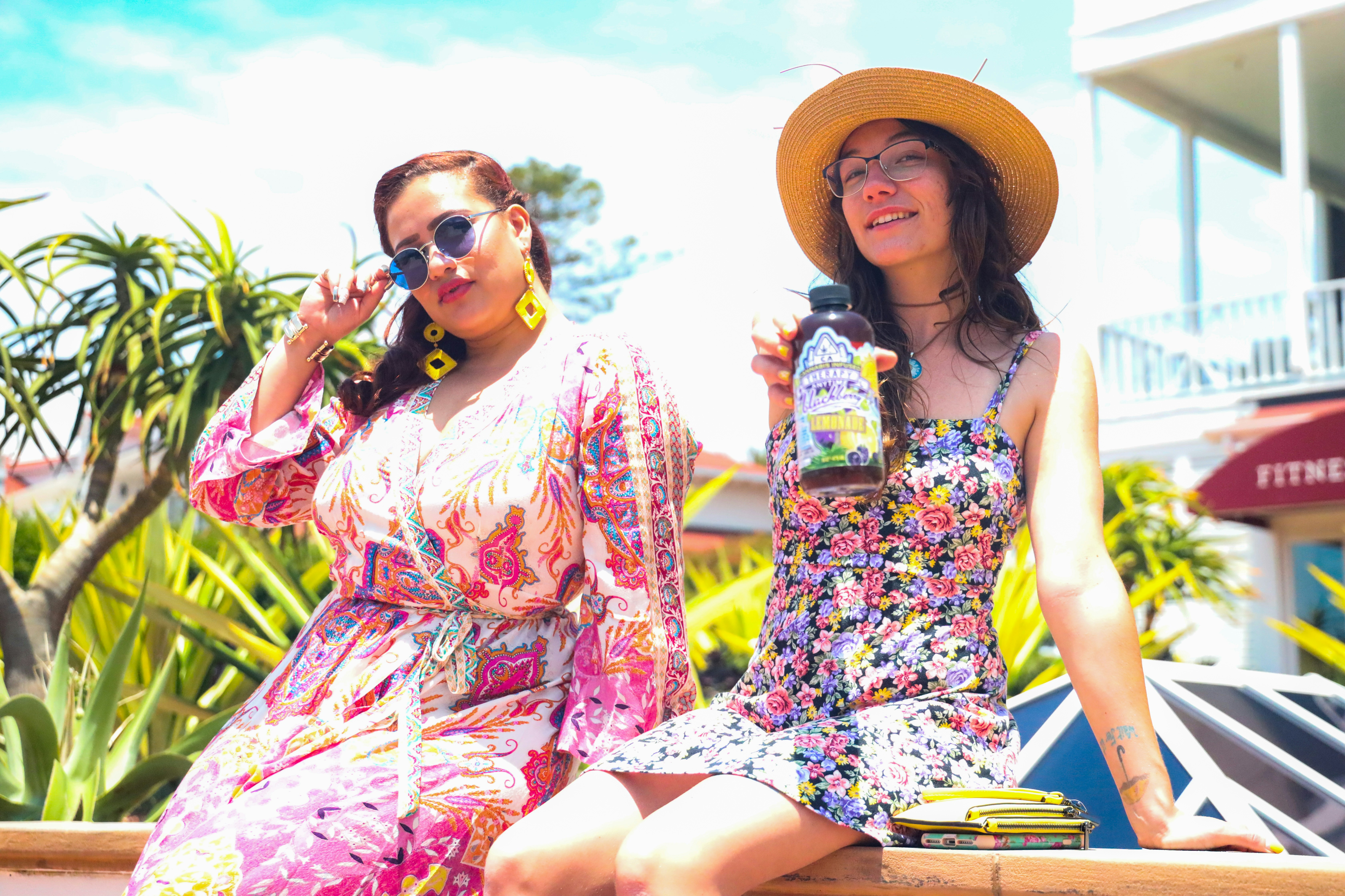 women with hat and shades summertime floral and paisley dresses