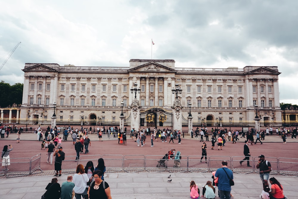 a group of people standing in front of a large building