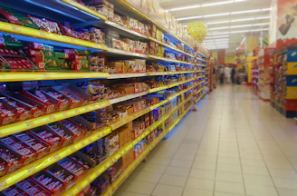 A neatly organized shelf filled with colorful packaged snacks and treats.