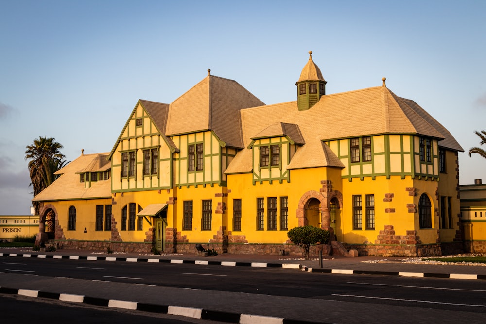 yellow concrete building beside road