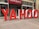 Large red and white letters spelling out 'YAHOO' are positioned outside a building labeled 'Global Business Centre.' The letters are three-dimensional and stand on the sidewalk, creating a striking visual against the building's facade.