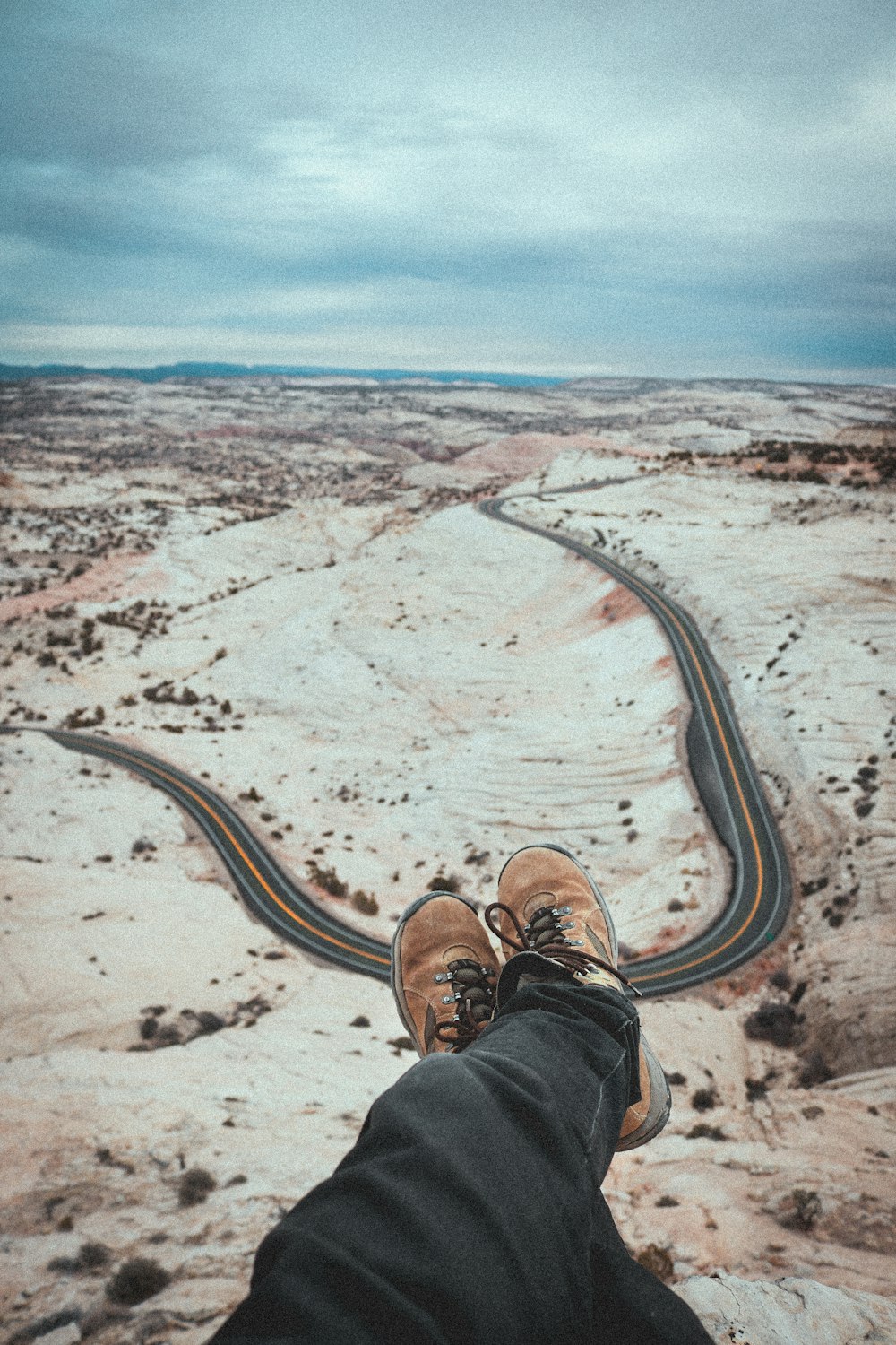 person sitting in front of brown sand dunes