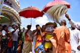 Devotees participating in a multicultural spiritual ceremony outdoors.