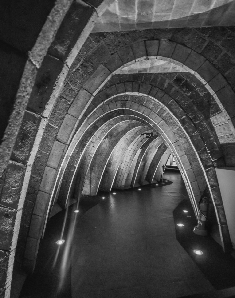 grayscale photography of tunnel