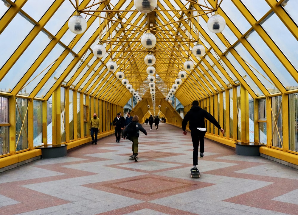 man skating on bridge during daytime