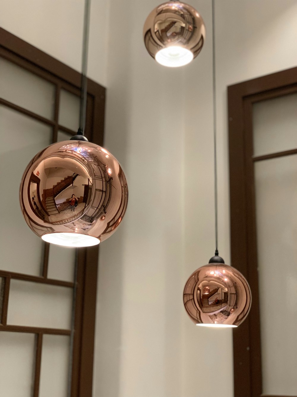 three gold pendant lamps