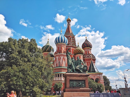 people walking near dome building during daytime in St. Basil's Cathedral Russia